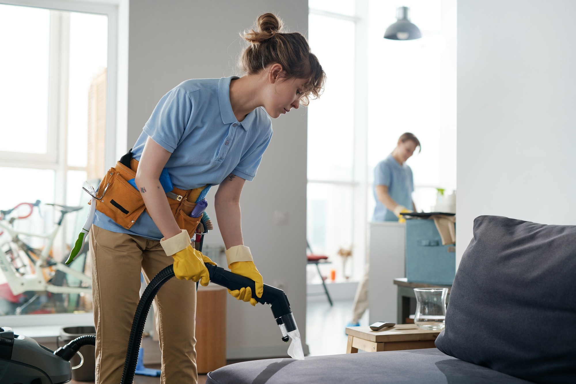 Cleaning service workers working in apartment in team